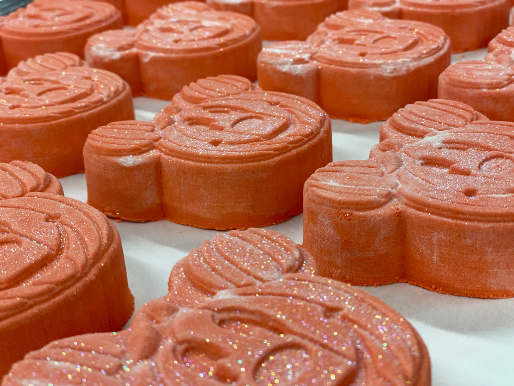 rows of orange colored pumpkin shaped mickey mouse bath bombs